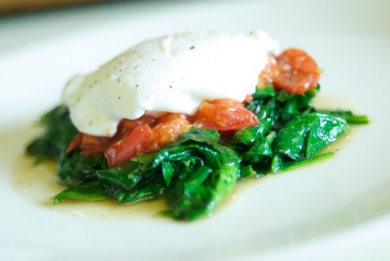 Poached eggs on a bed of spinach and tomatoes